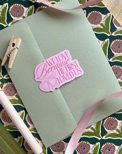 We Love Because He First Loved Us Sticker